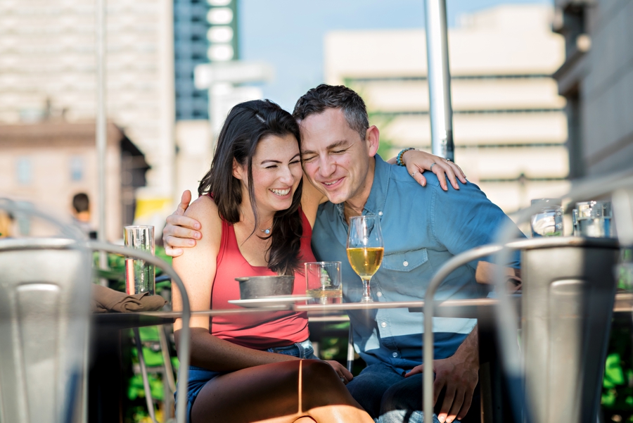 A couple have drinks during their Philly engagement session.
